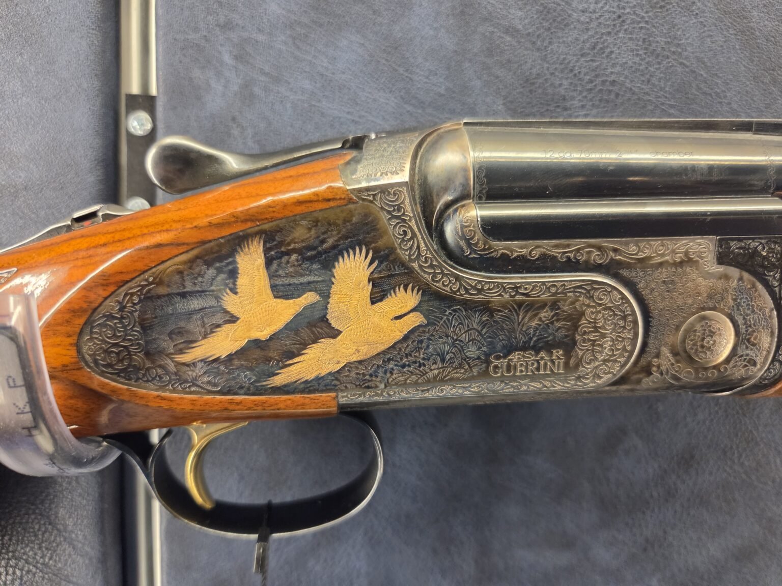 Engraved receiver with gold-inlaid game birds on the Caesar Guerini Magnus Sporting Limited